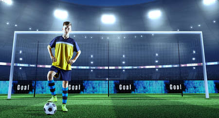 Young soccer player with ball in front of the goal on a professional 3D stadiumの写真素材