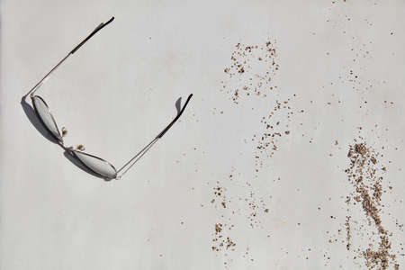 Aviator sunglasses with random pebble on sunbedの写真素材