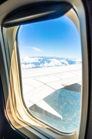 A captivating visual journey to Santa Marta, Colombia, blending breathtaking aerial perspectives with the serene beauty of its beaches. The collection features a stunning view from an airplane window, revealing the expansive white wing against a clear blue sky, with distant mountains and clouds hinting at the approach to a beautiful coastal destination. Complementing this is a serene sunset scene over the ocean near a beach, where a small boat gracefully traverses the calm waters under a vibrant orange sky, capturing the tranquil and picturesque essence of Santa Marta's Caribbean charm and inviting beach escapes. This set is ideal for showcasing travel, adventure, and the diverse beauty of Colombian landscapes and its coastal attractions.の写真素材