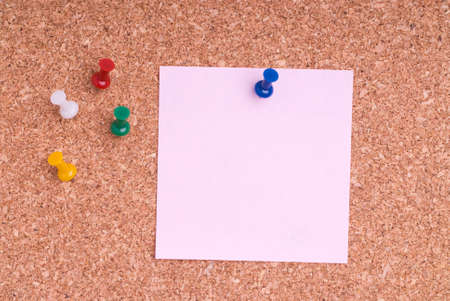 Pink Note Paper With Tacks On Cork Surfaceの写真素材