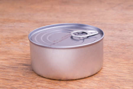 Closed Food Can on a Wooden Tableの写真素材