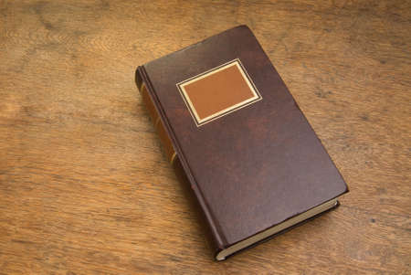 Closed Old Book on a Wooden Tableの写真素材
