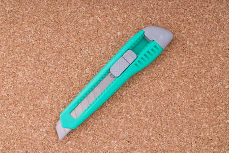 Box cutter on a Cork Board の写真素材