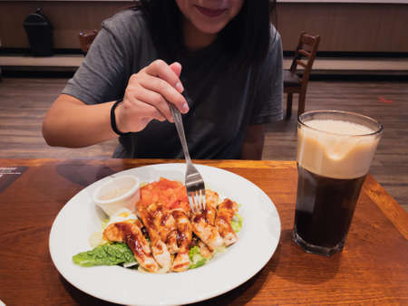 having lunch a salad of chicken and vegetables.の写真素材