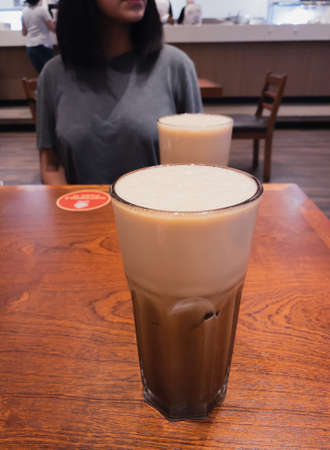 Person having an ice tea in a restaurant.の写真素材