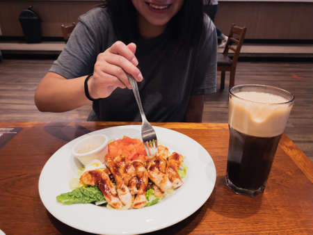 having lunch a salad of chicken and vegetables.の写真素材