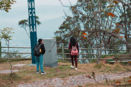 Two young women walking in the park on a sunny day.の写真素材