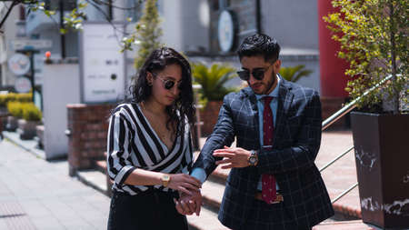 Couple of empresses walking in the city with elegant suits and happyの写真素材