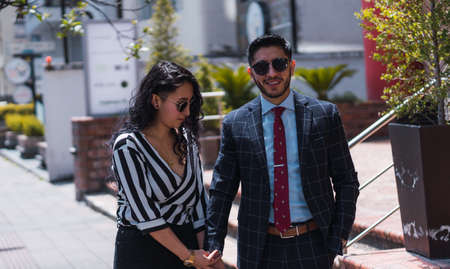 Couple of empresses walking in the city with elegant suits and happyの写真素材