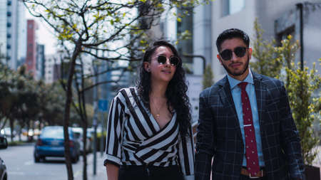 Couple of empresses walking in the city with elegant suits and happyの写真素材