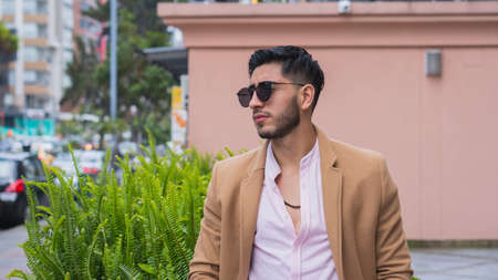 Young business man walking through the cityの写真素材