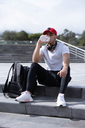 Young man listening to music to perform different exercises and get inspired.の写真素材