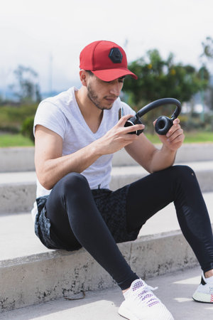 Young man listening to music to perform different exercises and get inspired.の写真素材