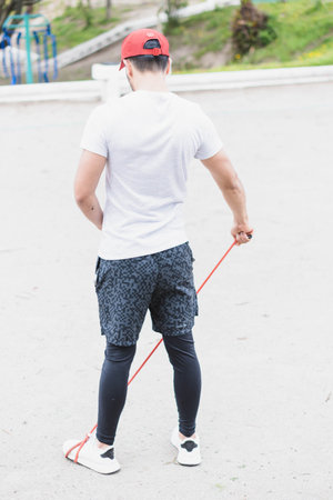 Young man doing different warm-up and cardio exercises in the park.の写真素材