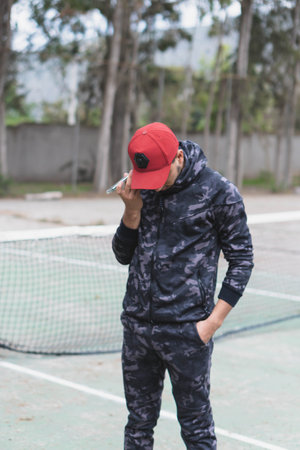 Young man doing different warm-up and cardio exercises in the park.の写真素材