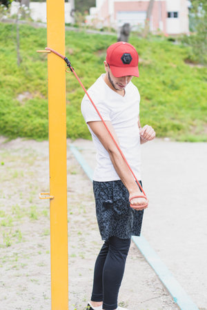 Young man doing different warm-up and cardio exercises in the park.の写真素材