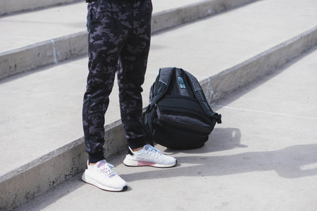 Young man doing different warm-up and cardio exercises in the park.の写真素材