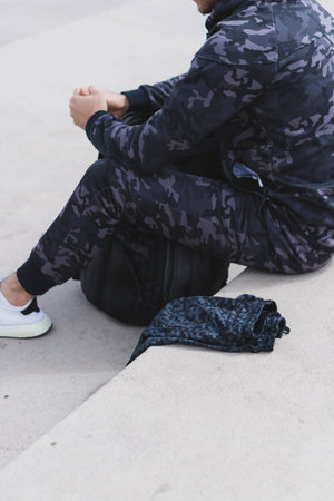 Young man doing different warm-up and cardio exercises in the park.の写真素材