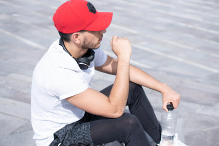 Young man doing different warm-up and cardio exercises in the park.の写真素材