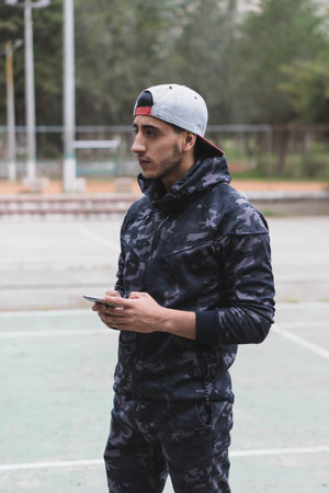 Young man doing different warm-up and cardio exercises in the park.の写真素材