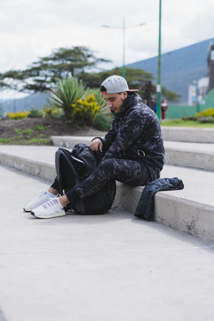 Young man doing different warm-up and cardio exercises in the park.の写真素材