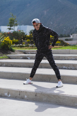 Young man doing different warm-up and cardio exercises in the park.の写真素材