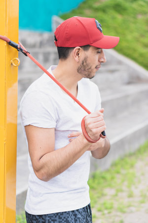 Young man doing different warm-up and cardio exercises in the park.の写真素材