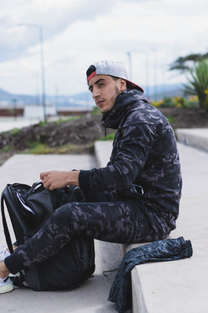 Young man doing different warm-up and cardio exercises in the park.の写真素材