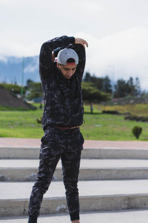 Young man doing different warm-up and cardio exercises in the park.の写真素材
