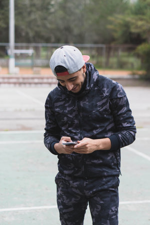 Young man doing different warm-up and cardio exercises in the park.の写真素材