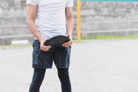 Young man doing different warm-up and cardio exercises in the park.の写真素材