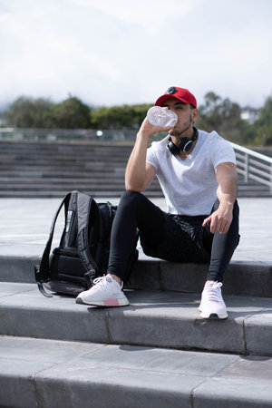 Young man doing different warm-up and cardio exercises in the park.の写真素材