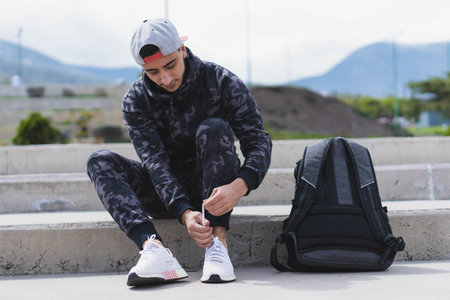 Young man doing different warm-up and cardio exercises in the park.の写真素材
