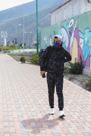 Young man doing different warm-up and cardio exercises in the park.の写真素材