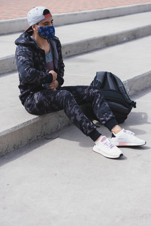 Young man doing different warm-up and cardio exercises in the park.の写真素材