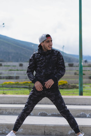 Young man doing different warm-up and cardio exercises in the park.の写真素材