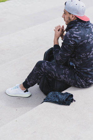 Young man doing different warm-up and cardio exercises in the park.の写真素材