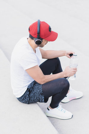 Young man doing different warm-up and cardio exercises in the park.の写真素材