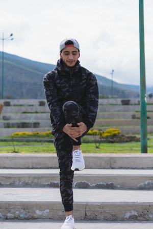 Young man doing different warm-up and cardio exercises in the park.の写真素材