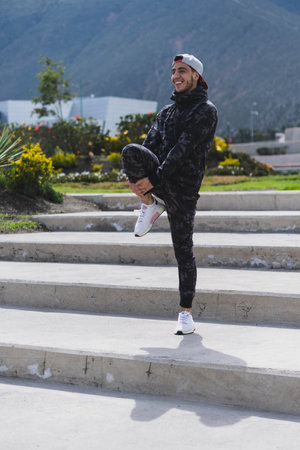 Young man doing different warm-up and cardio exercises in the park.の写真素材