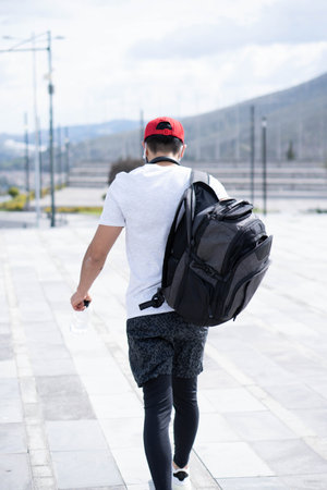 Young man doing different warm-up and cardio exercises in the park.の写真素材