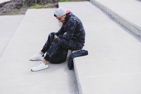 Young man doing different warm-up and cardio exercises in the park.の写真素材