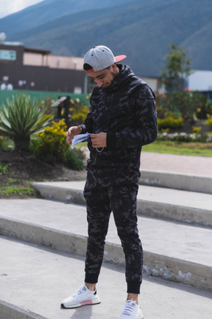 Young man doing different warm-up and cardio exercises in the park.の写真素材