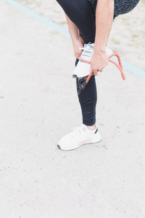Young man doing different warm-up and cardio exercises in the park.の写真素材