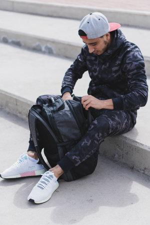 Young man doing different warm-up and cardio exercises in the park.の写真素材
