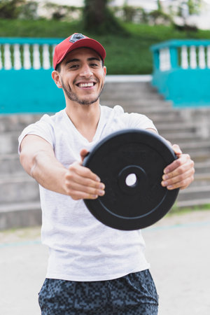 Young man doing different warm-up and cardio exercises in the park.の写真素材