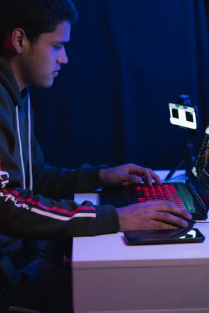 Young man doing a live video game sharing online. On different streaming platforms.の写真素材