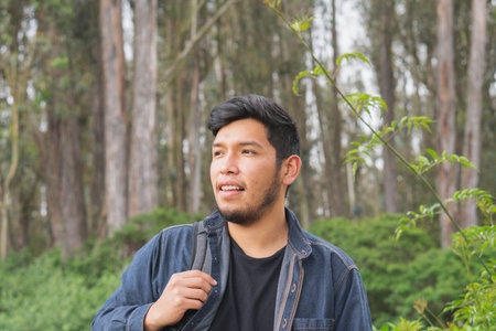 Young man walking in the woods taking selfies. To show your friends.の写真素材