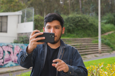 Young man walking in the woods taking selfies. To show your friends.の写真素材