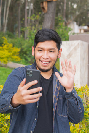 Young man walking in the woods taking selfies. To show your friends.の写真素材